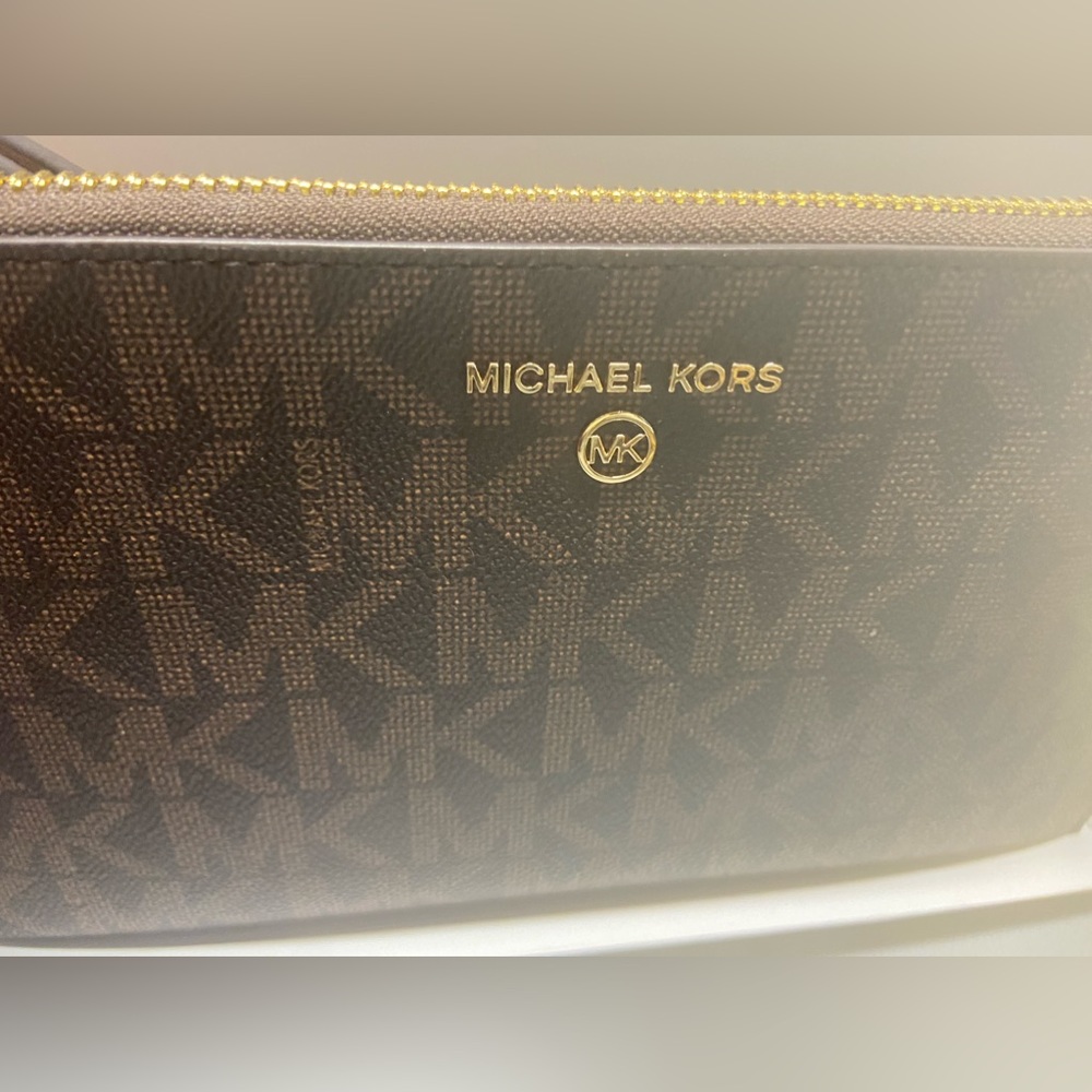 Michael Kors wristlet. New with tag. Still in box.